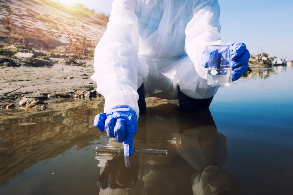 a scientist getting water samples to test for toxin and pollution level