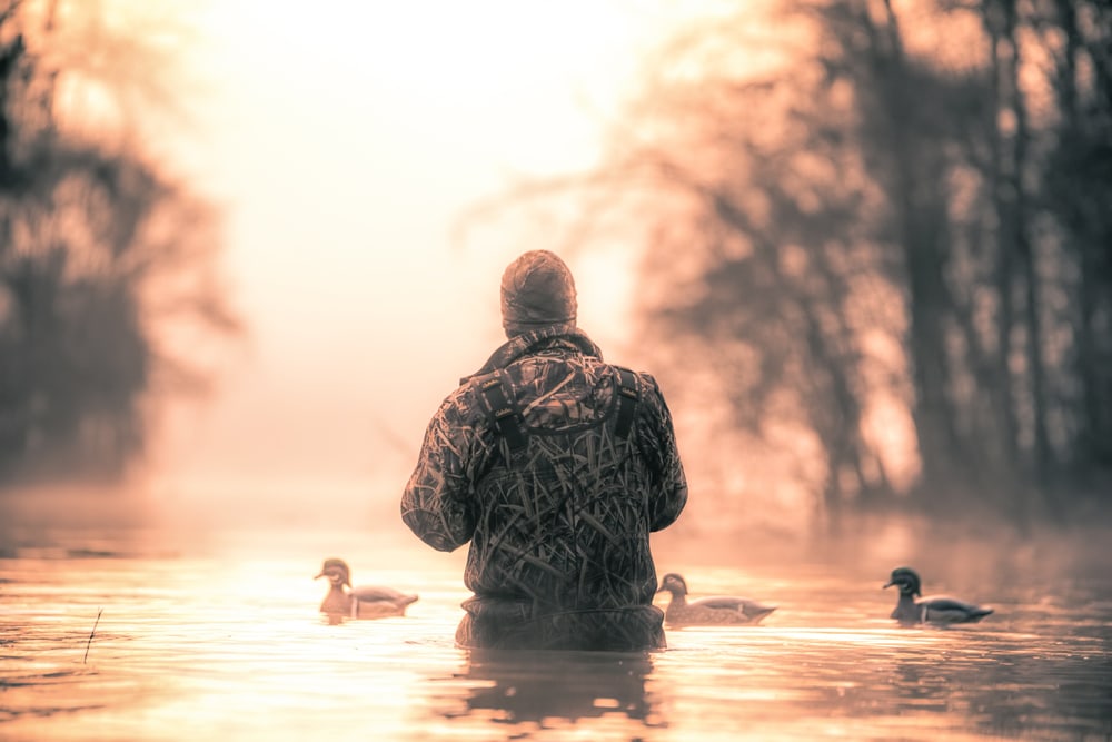 a hunter going to hunt for ducks in the lake