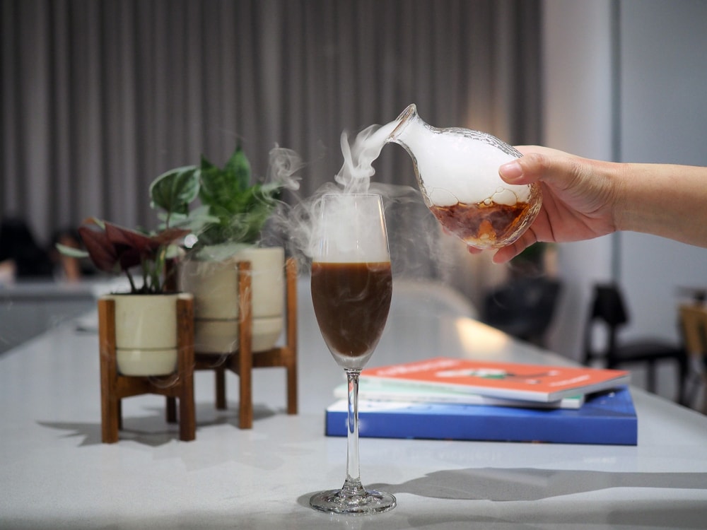 Dry ice being poured on a glass