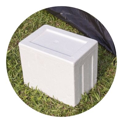 Styrofoam dry ice cooler on the ground