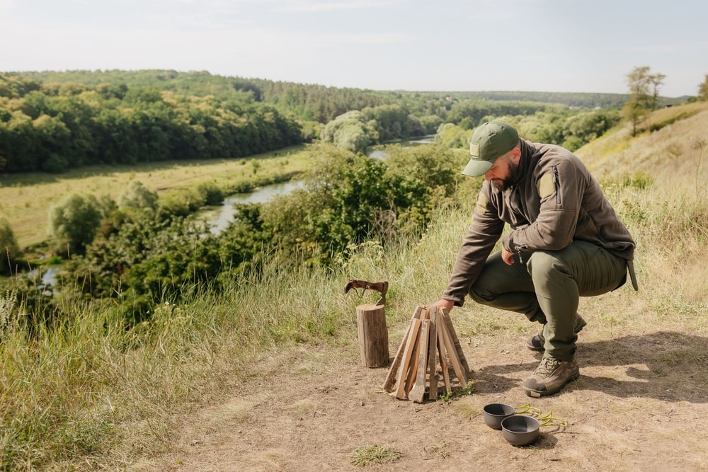 a man preparing a campfire