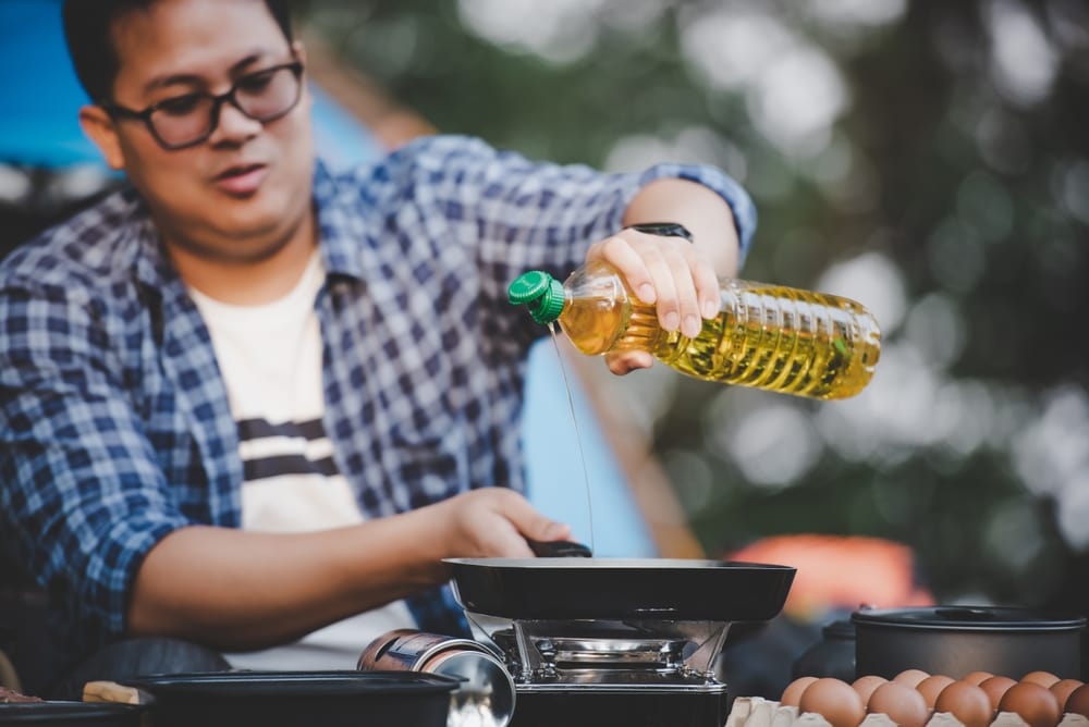 Man putting cooking oil on a pan