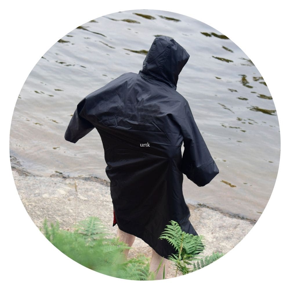 a man wearing black changing robe