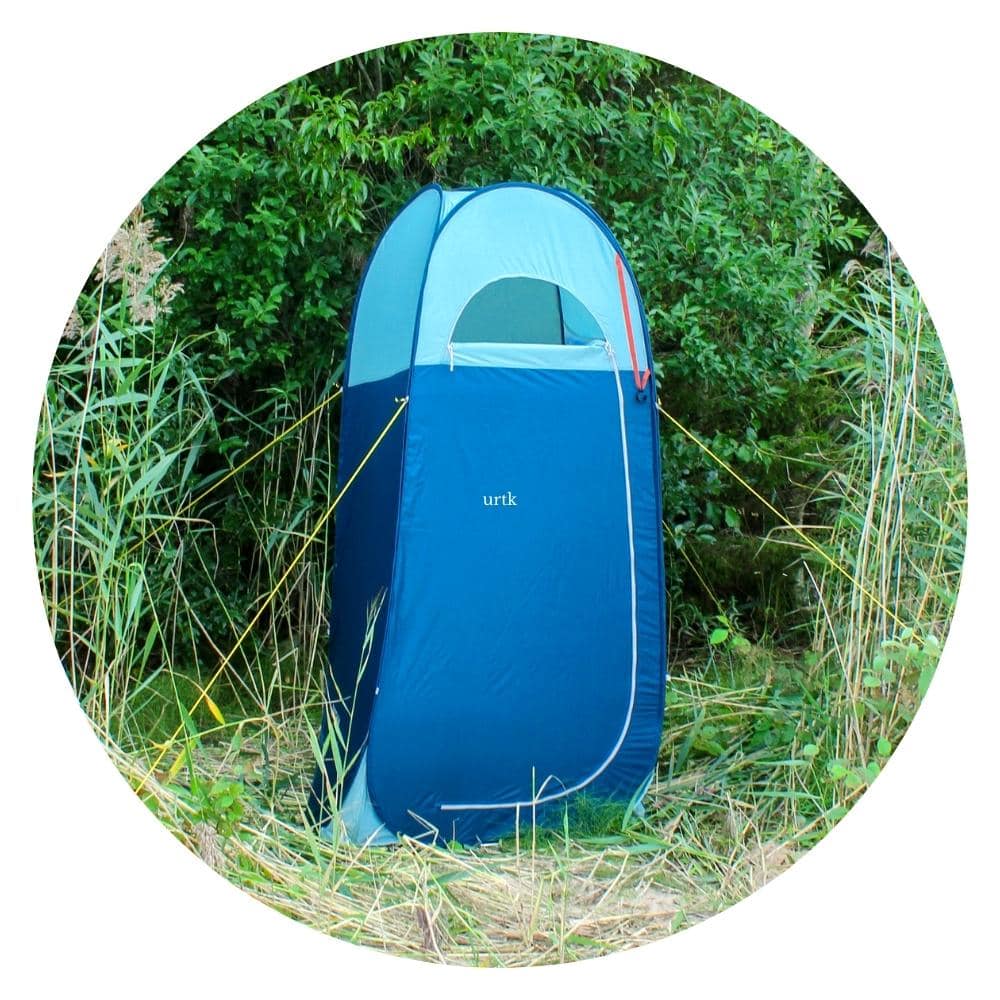 blue privacy tent in the grass