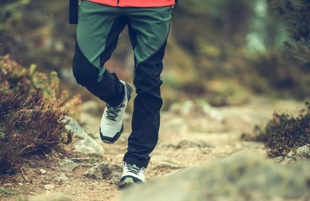 A man wearing green and hiking pants