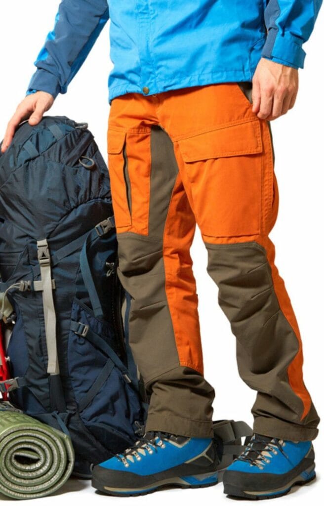 man wearing an orange and brown hard-shell pants with equipments