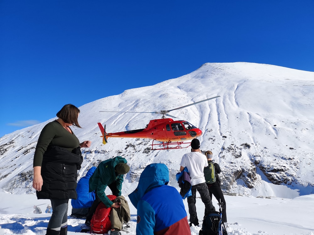 Group of Heli-Hikers at a mountain filled with snow