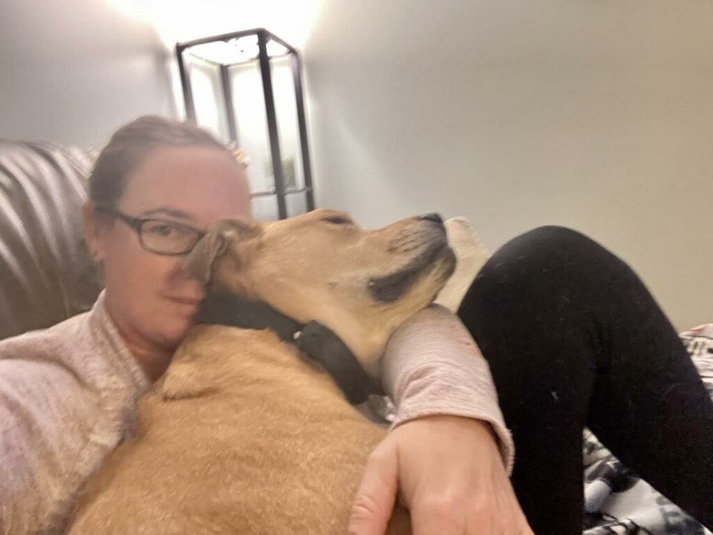 Columbo sleeping peacefully in Andrea Shaw's arms