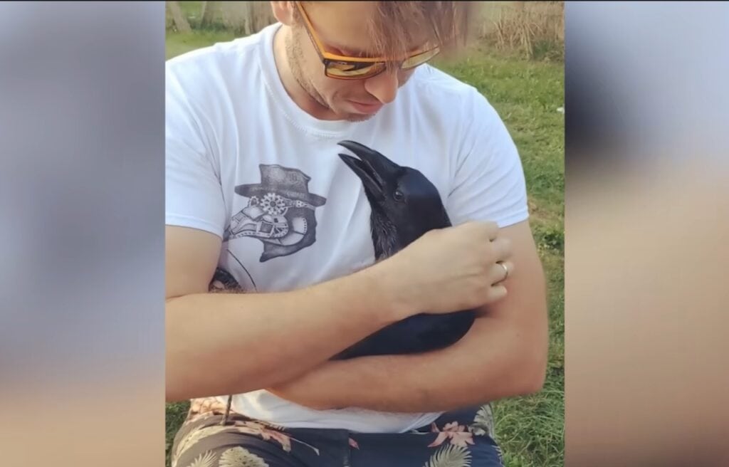 Elliot holding Loki in his arms