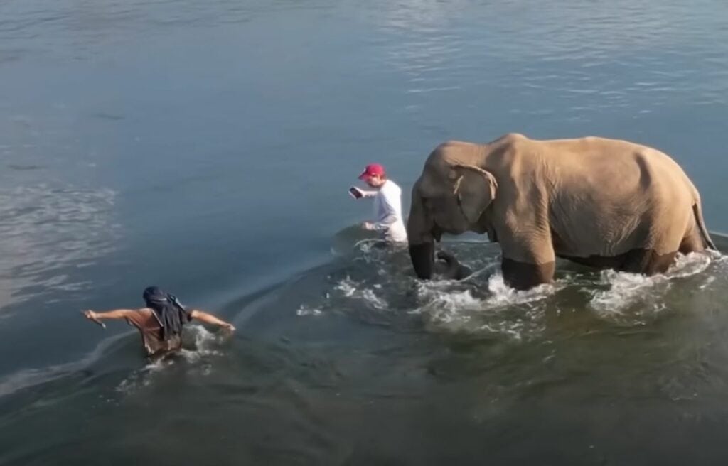 Aaron and Bouakham crossing the Mekong River